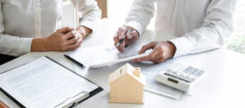 Real estate broker agent presenting and consult to customer to decision making sign insurance form agreement, home model, concerning mortgage loan offer for and house insurance